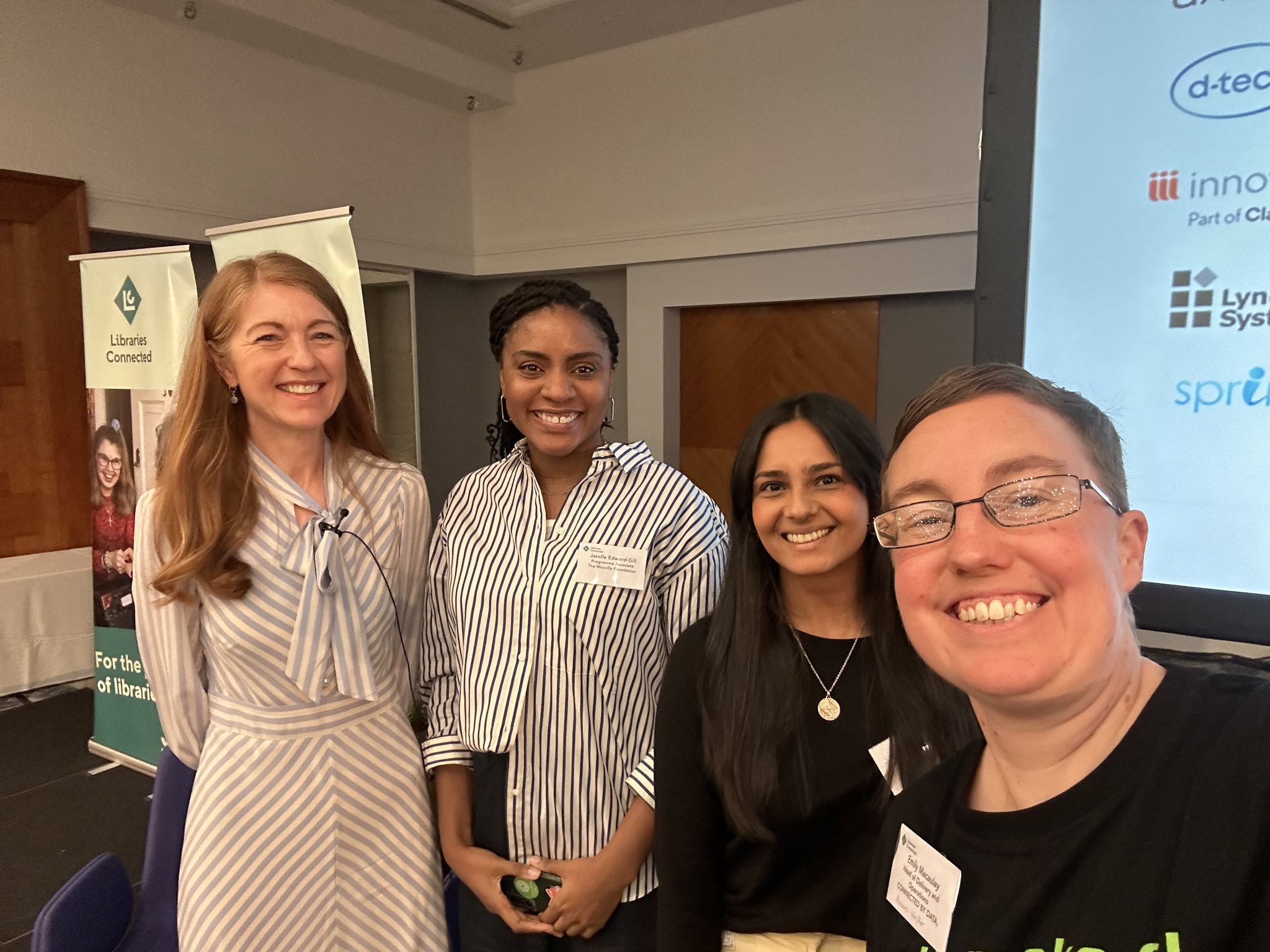 Selfie of the four Panel speakers all grinning at the camera"