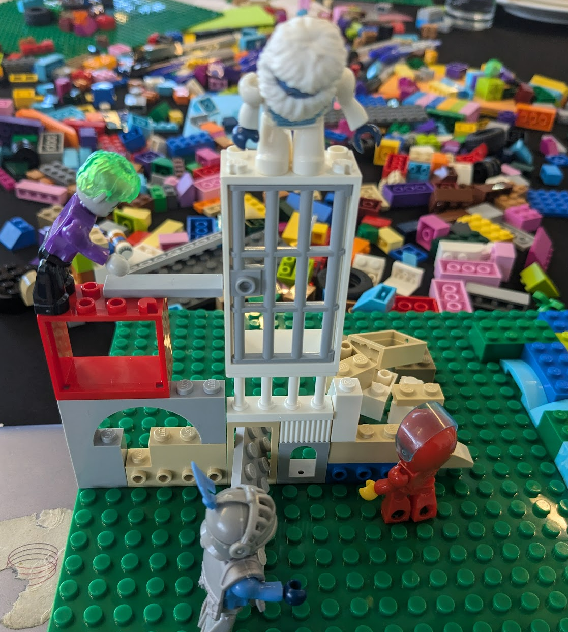 Photo of lego model representing different models of participatory data stewardship: people building their own models, oversight of official models, and resistance to dominant models.