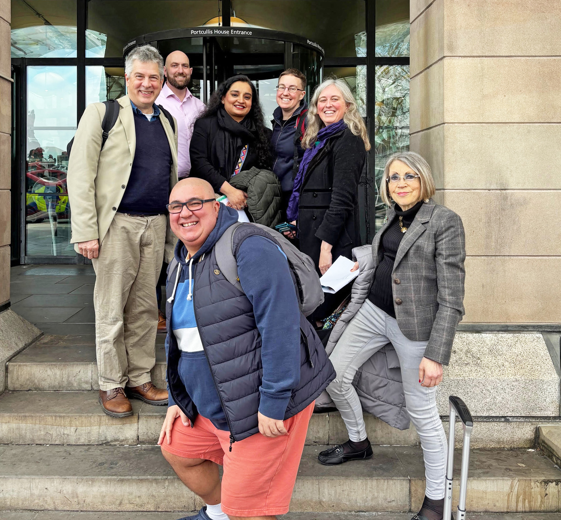 Members of the PVAI People’s Advisory Panel, plus Anna and Emily, outside Portcullis House ahead of providing their key messages to policy makers (March 2025)